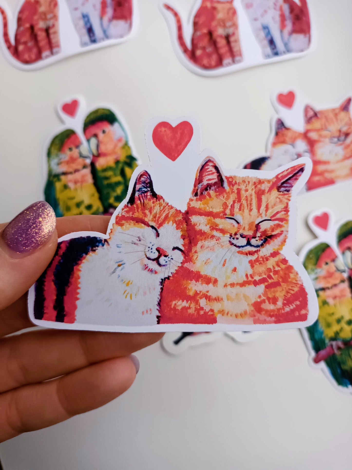 Romantic cats in love sticker, close-up hand-drawn illustration, waterproof vinyl decal held by hand