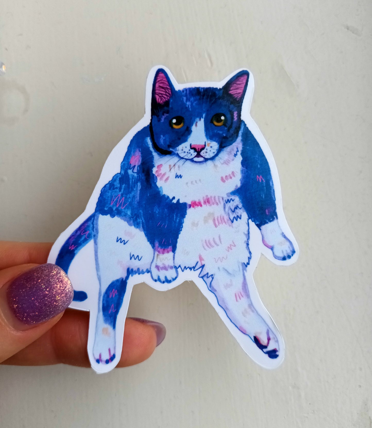 Sassy sitting cat sticker, hand-drawn illustration, waterproof vinyl decal held by hand