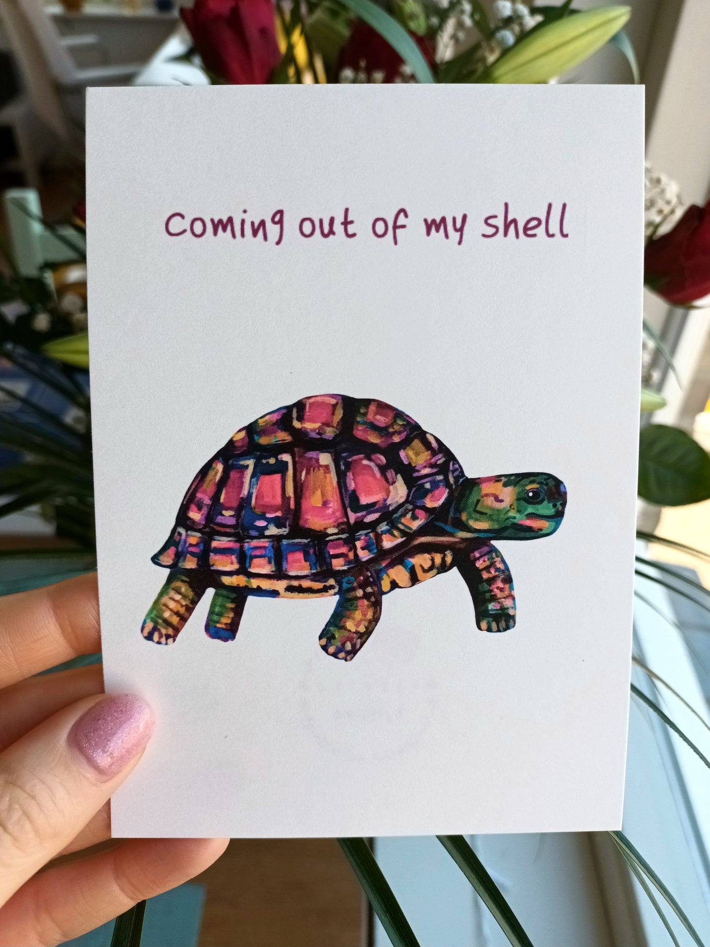 Handmade colourful postcard featuring a cute turtle emerging from its shell, high-quality illustration art card held by hand