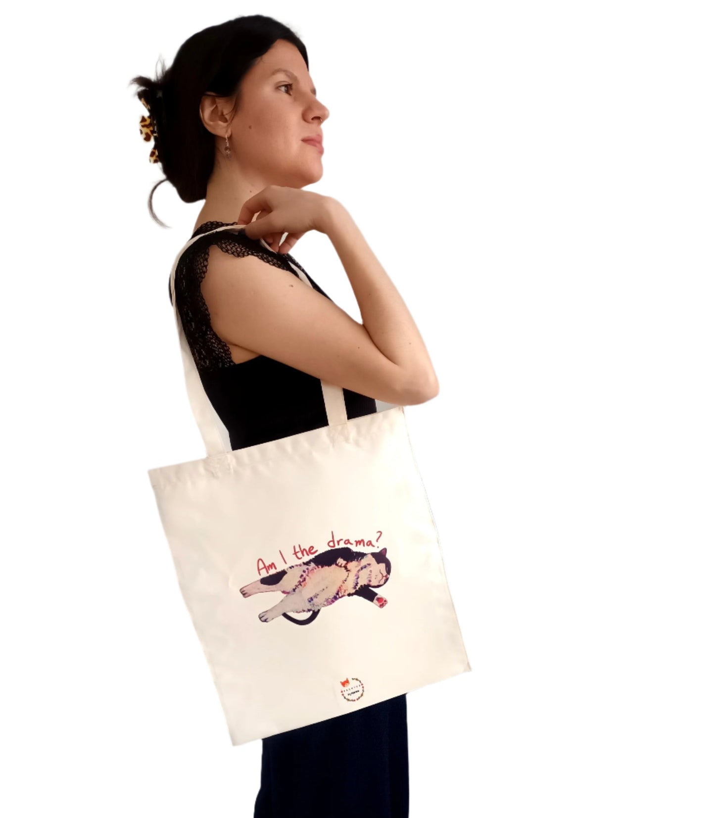 Double-sided tote bag featuring a funny dramatic cat. This side says "Am I the Drama?". Printed on durable, waterproof polyester. Perfect for cat lovers and drama queens.