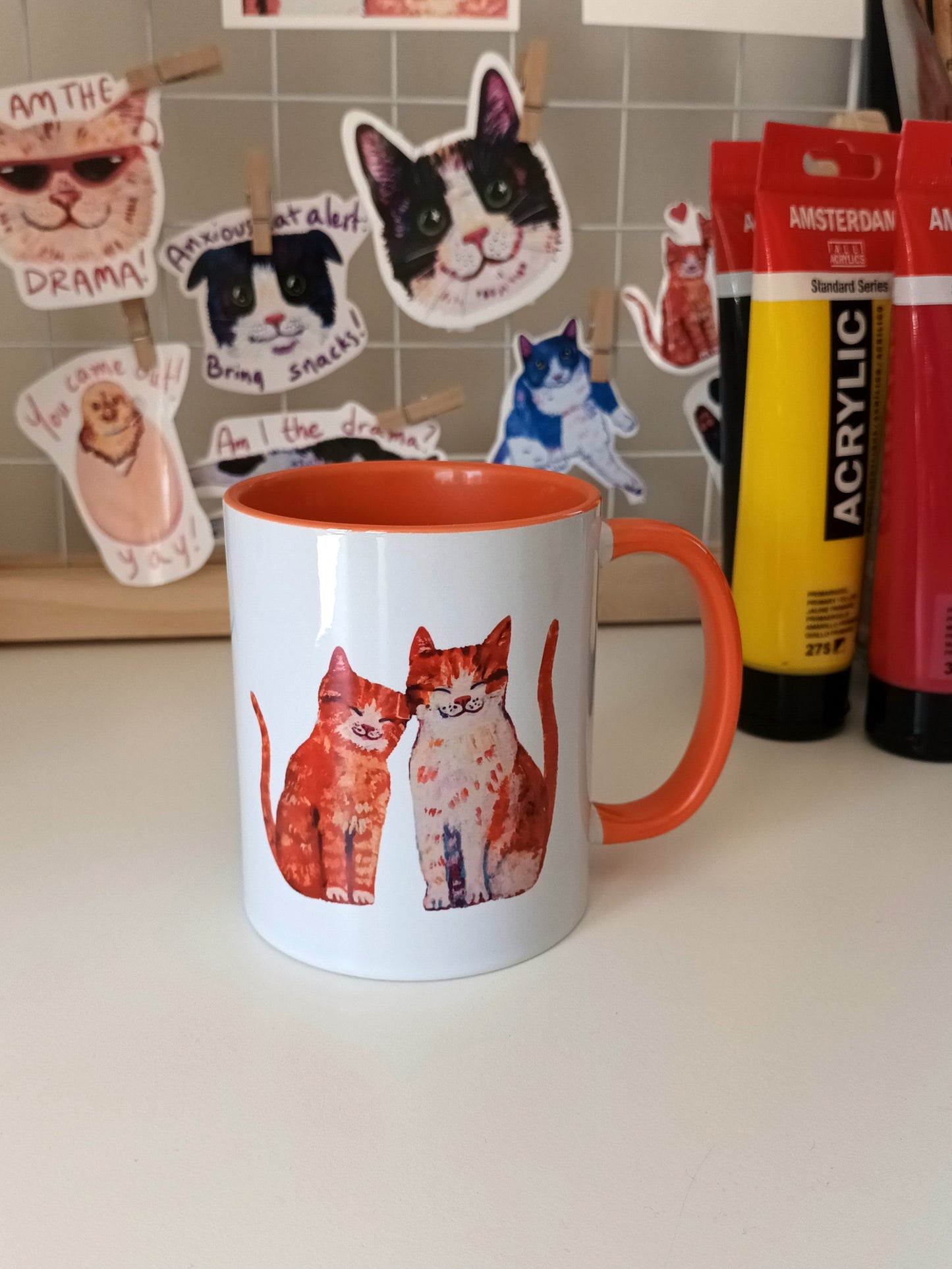 Handmade mug with two cute cats in love – orange handle and interior, perfect for cat lovers.