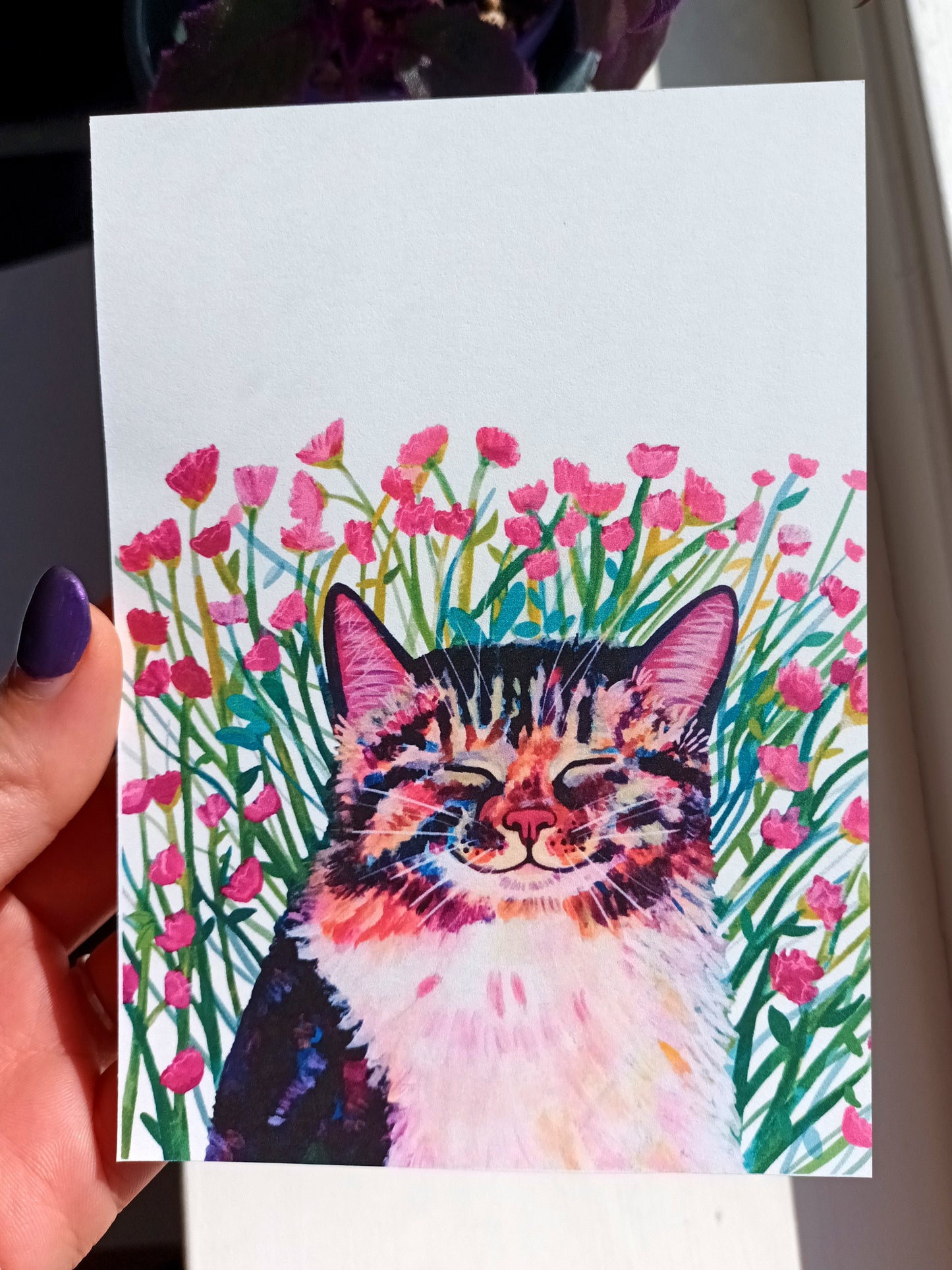 Cute illustrated postcard of a cat surrounded by pink blossoms.