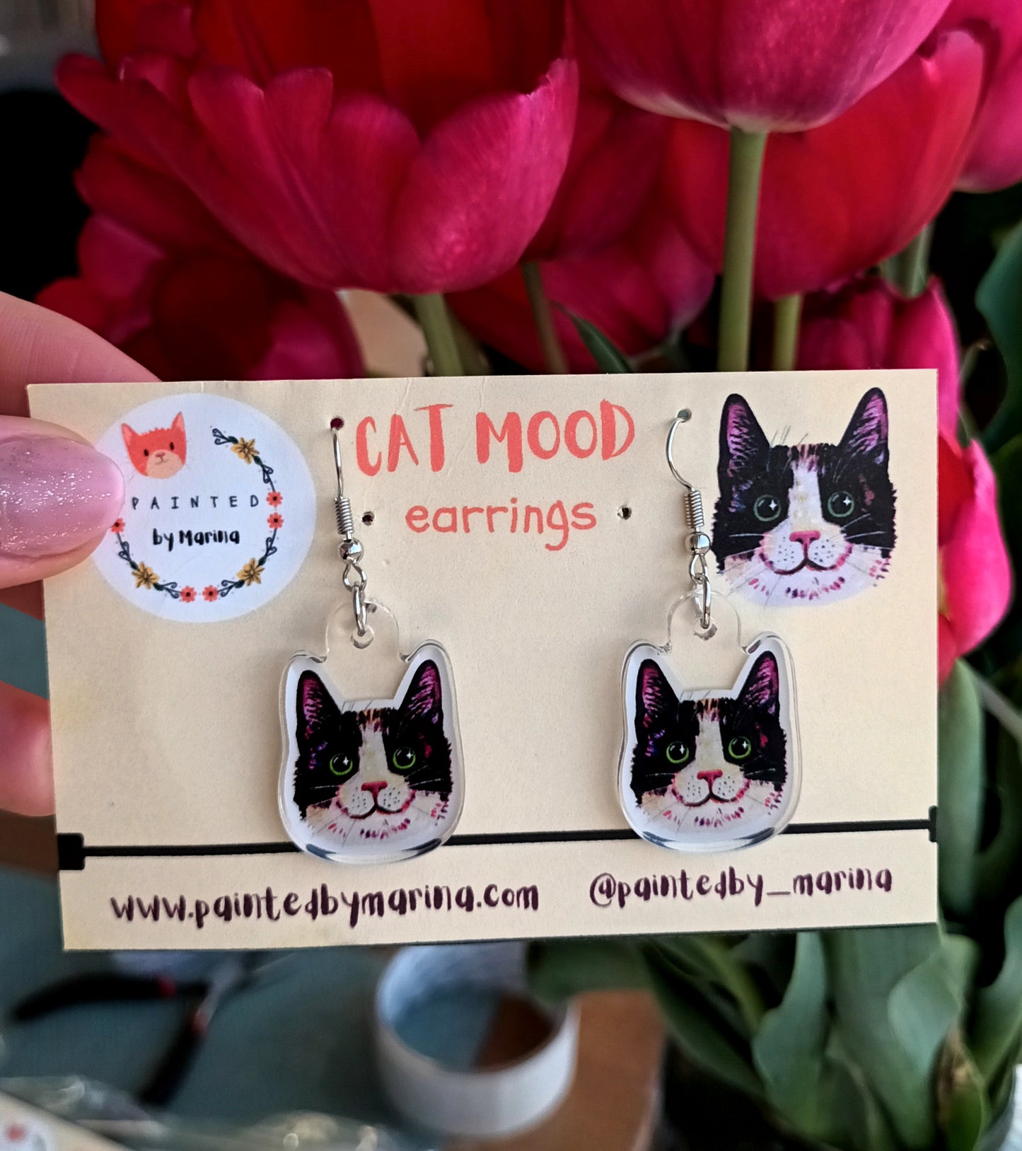 Cute handmade earrings with smiling black tuxedo cat faces.