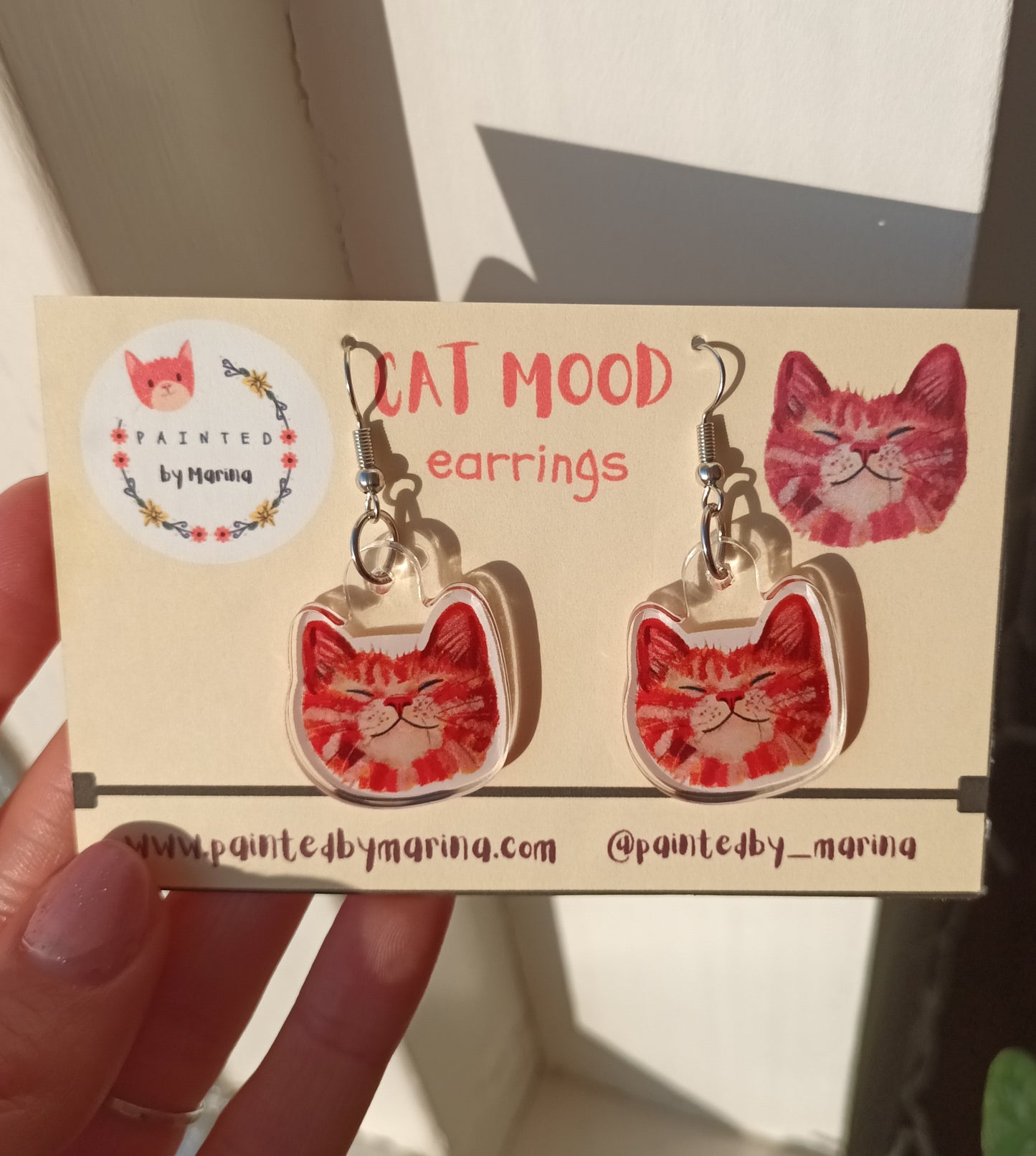 Handmade earrings with smiling orange cat faces, stainless steel, approximately 2.5 x 2.5 cm.