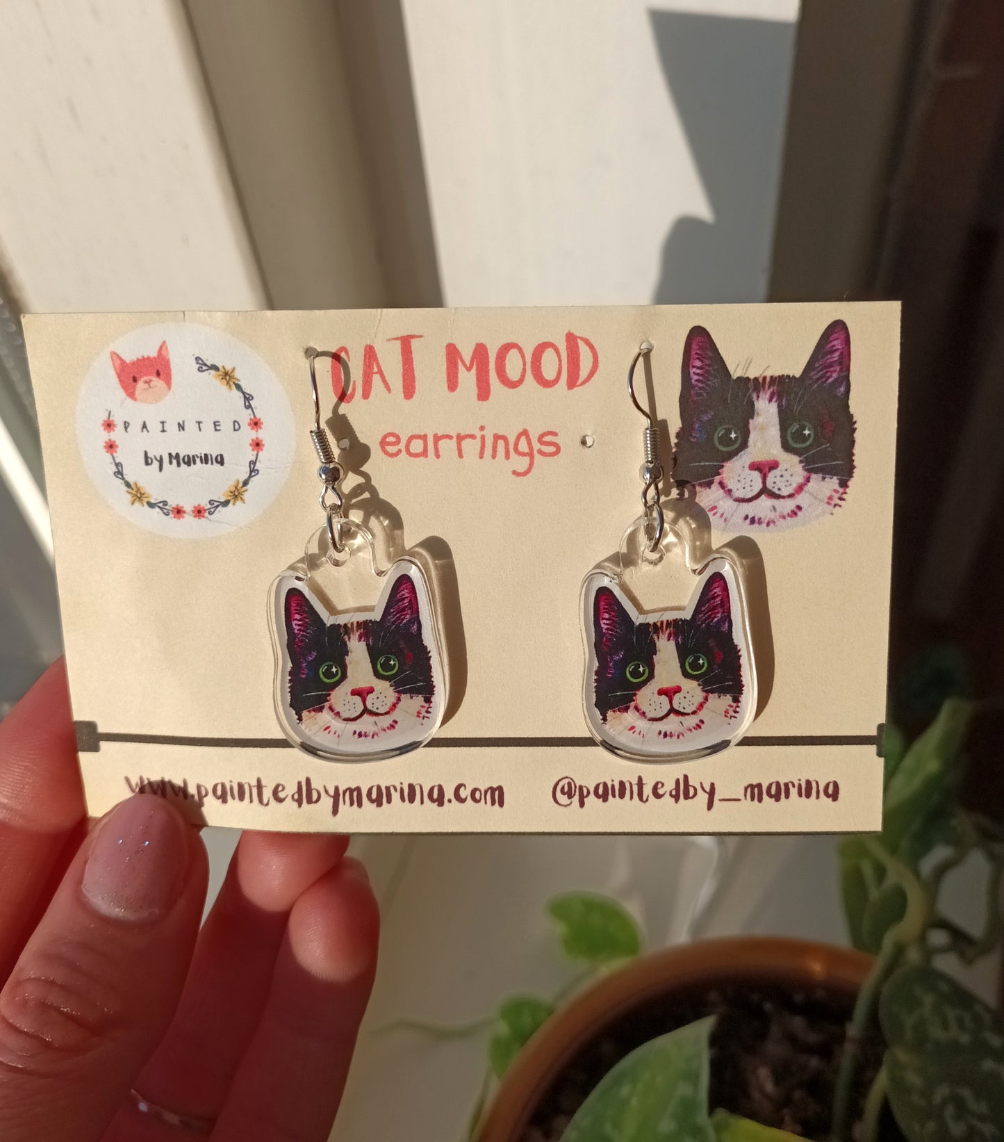 Handmade earrings with smiling black tuxedo cat faces, stainless steel, approximately 2.5 x 2.5 cm.