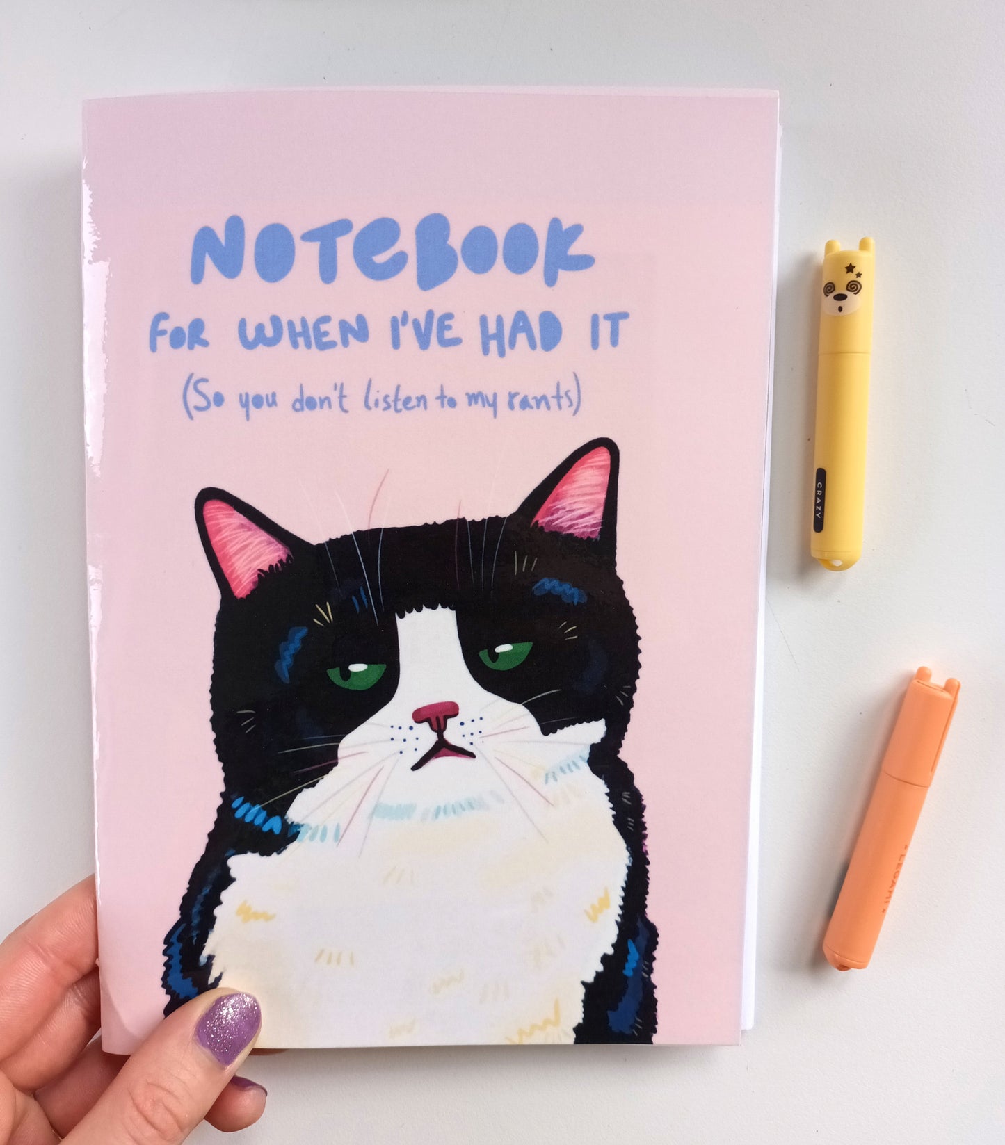 Handmade notebook with a grumpy black cat and the text “Notebook for when I’ve had it, so you don’t listen to my rants”, blank pages inside and hand-stitched binding