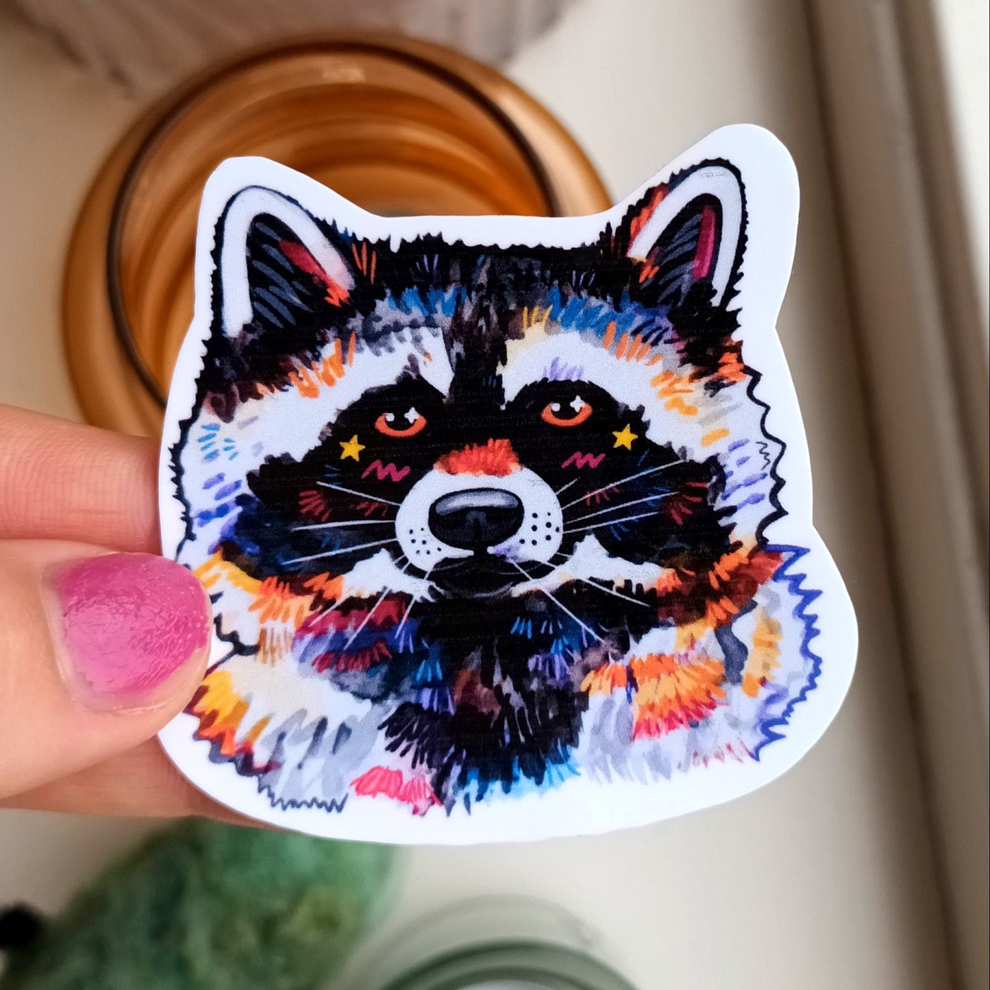Cute vinyl sticker of a raccoon on waterproof vinyl, approximately 6 x 6 cm