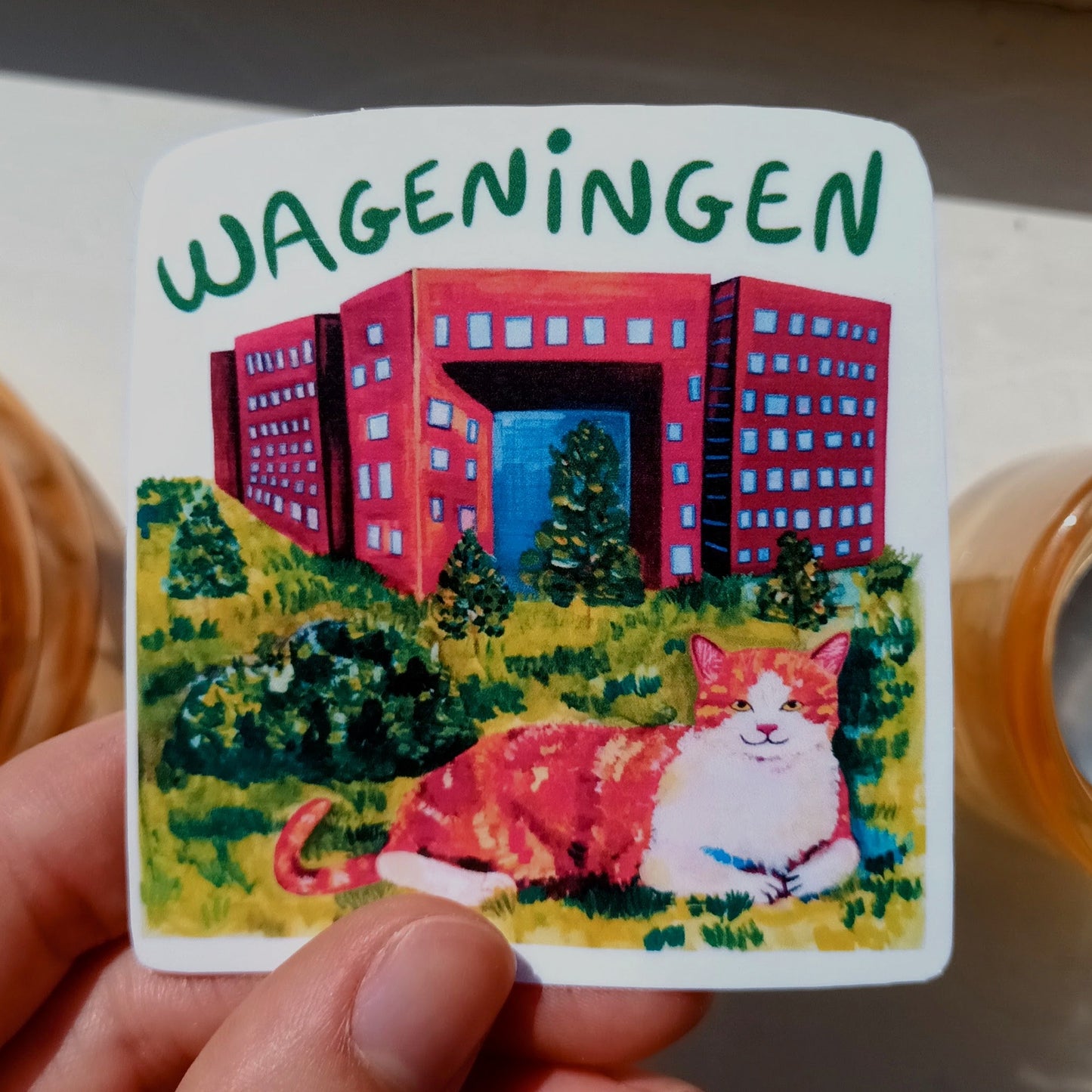 Wageningen sticker with cute orange cat in front of Forum building