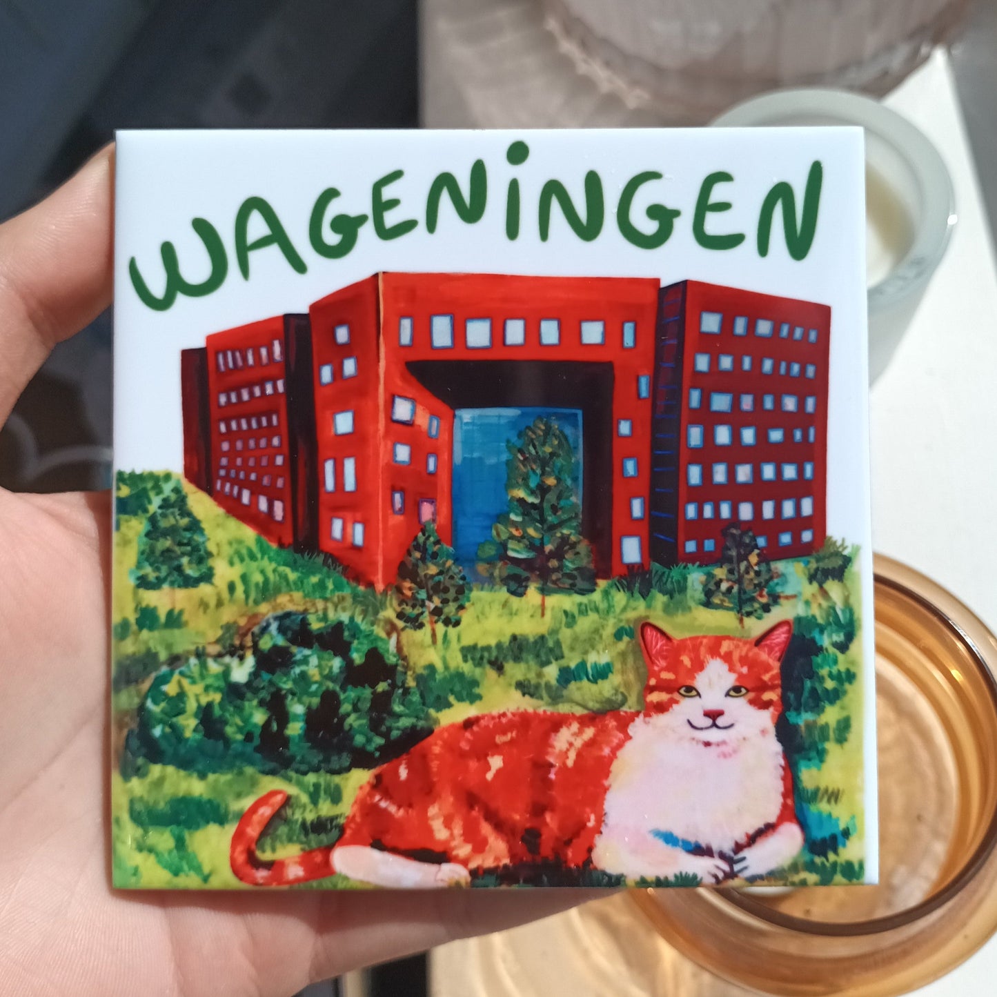 Handmade Wageningen ceramic tile with orange cat and Forum building