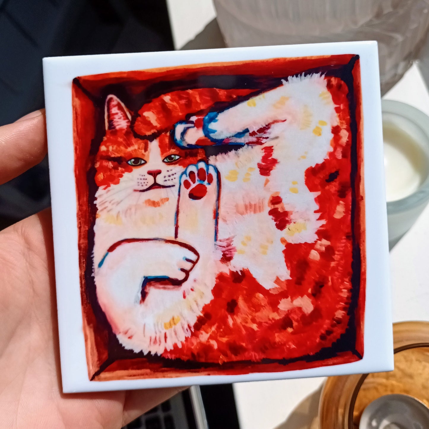 Handmade ceramic tile with cute orange cat in a box