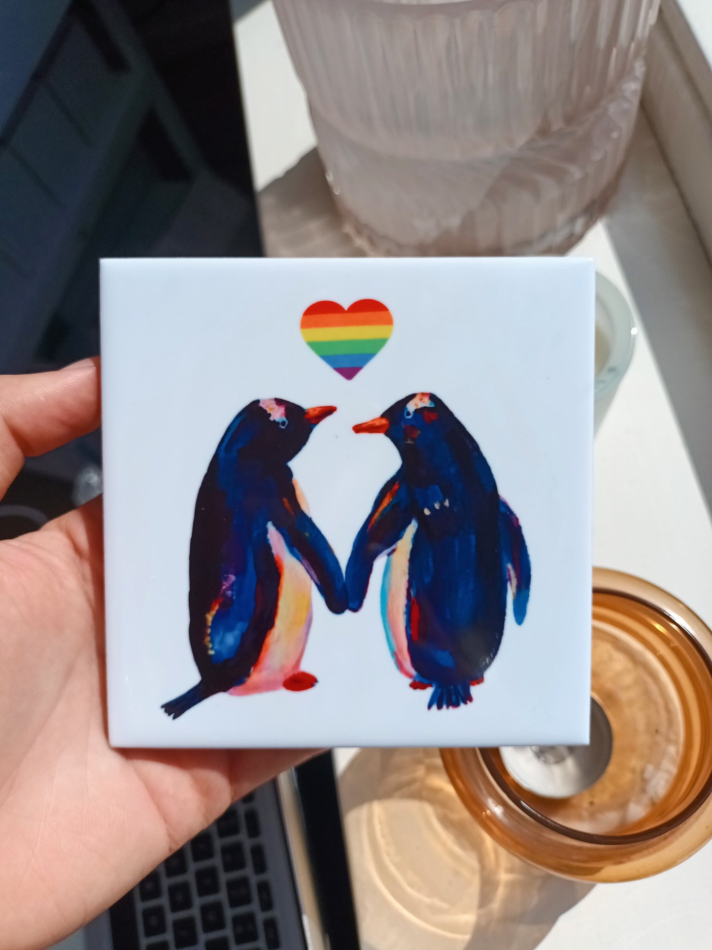 Handmade ceramic tile with two penguins holding rainbow pride flag