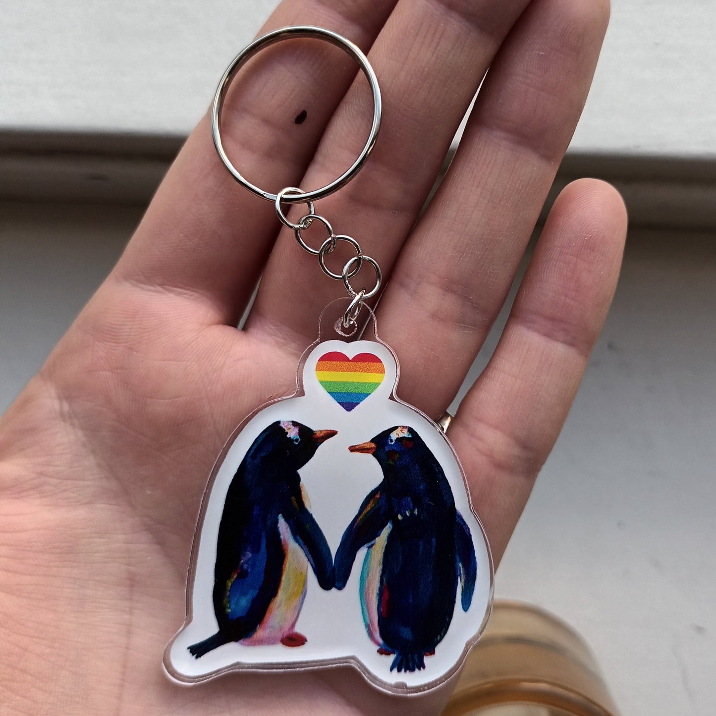 Acrylic keychain with two penguins and a rainbow heart