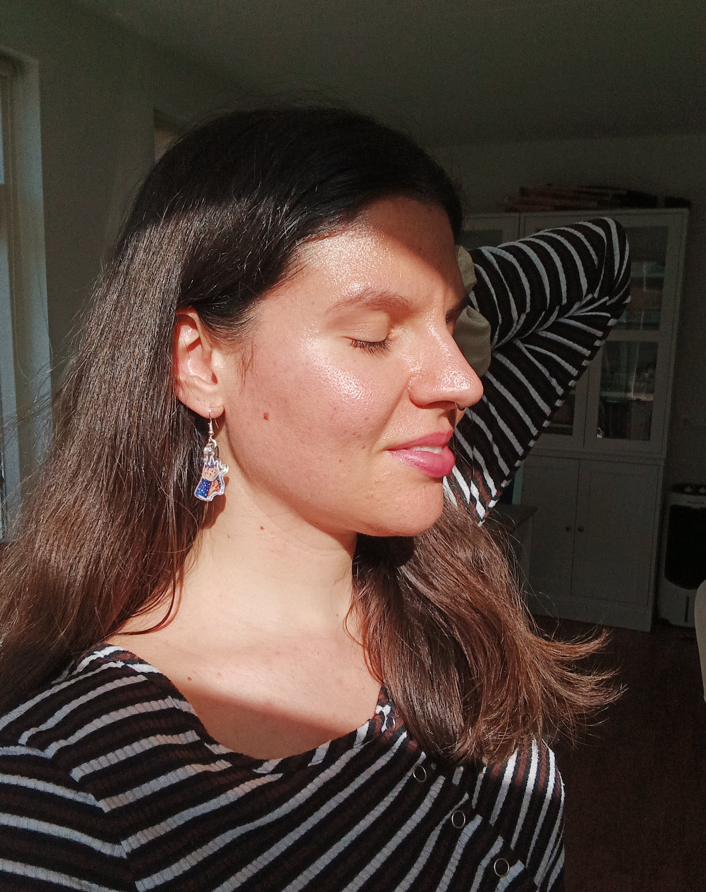 Woman wearing handmade hamster wizard earrings with stainless steel hooks