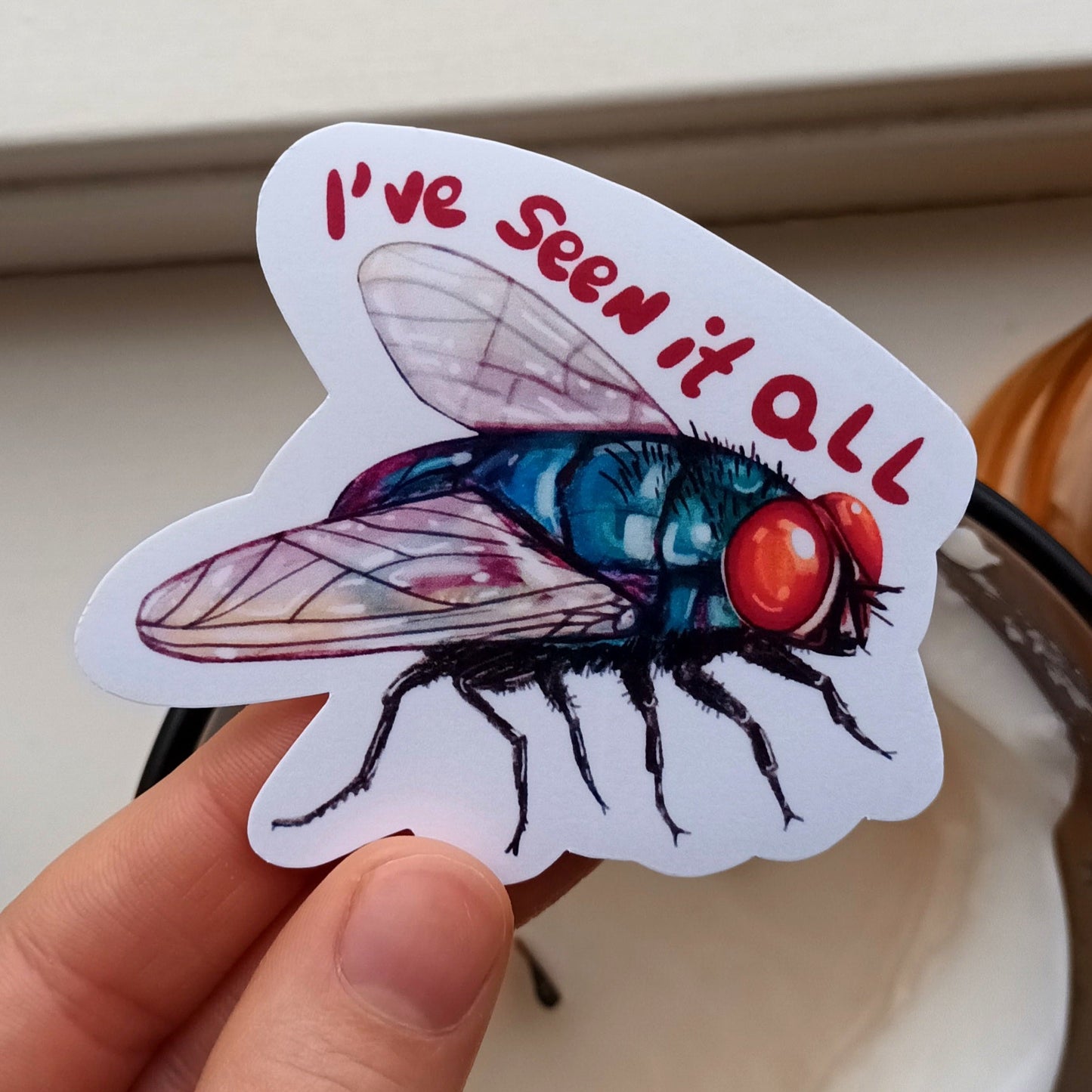 Green bottle fly sticker with “I’ve Seen It All” text, original illustration by the artist, 7.5 x 6.52 cm