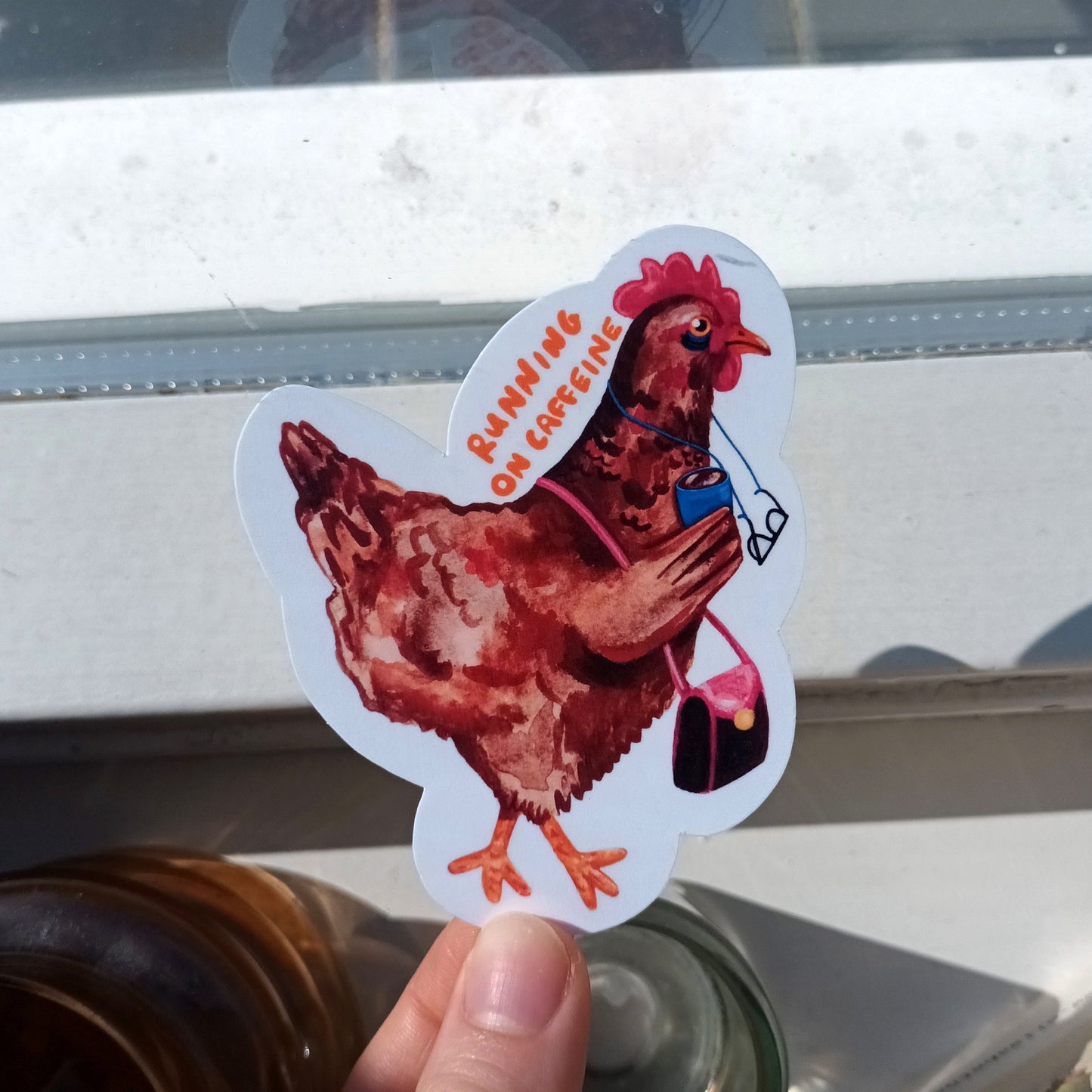 Sticker of a tired chicken drinking coffee.