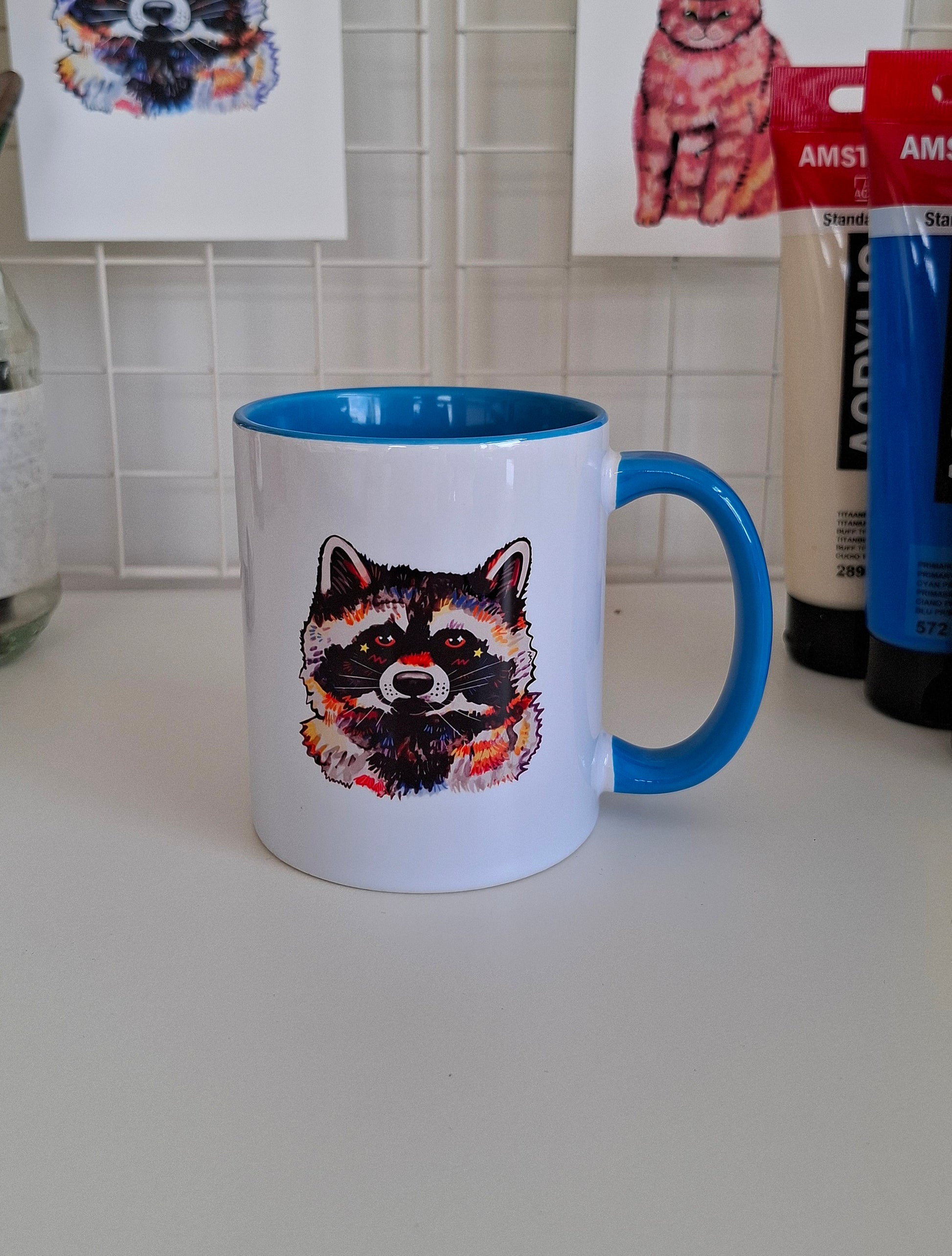 Mug with raccoon design on a kitchen counter
