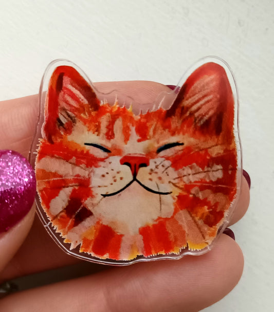 Cute orange cat face acrylic pin with a soft PVC clutch. High-quality glossy finish, perfect for jackets, bags, or collectors.