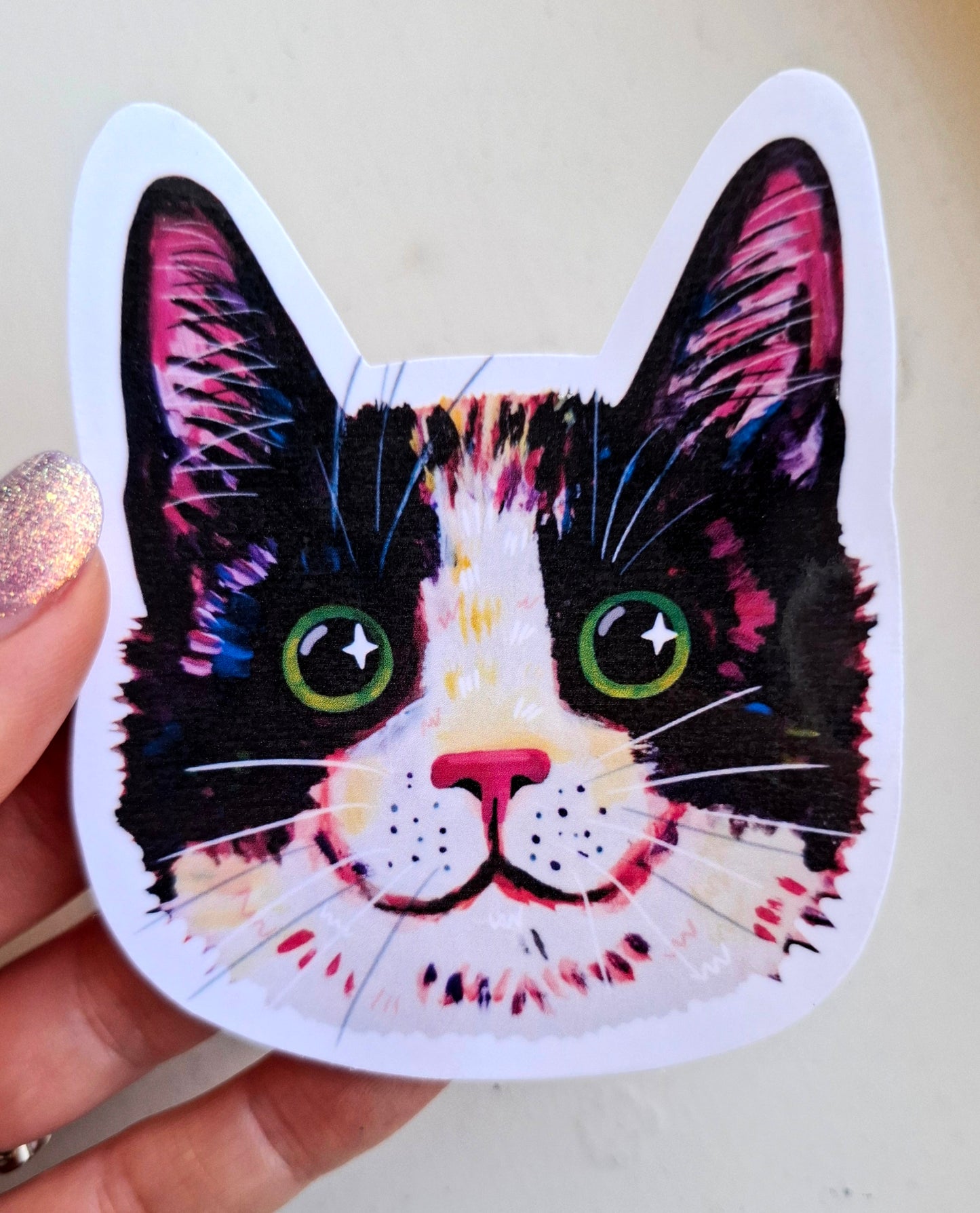 Happy cat face sticker, hand-drawn illustration, waterproof vinyl decal held by hand