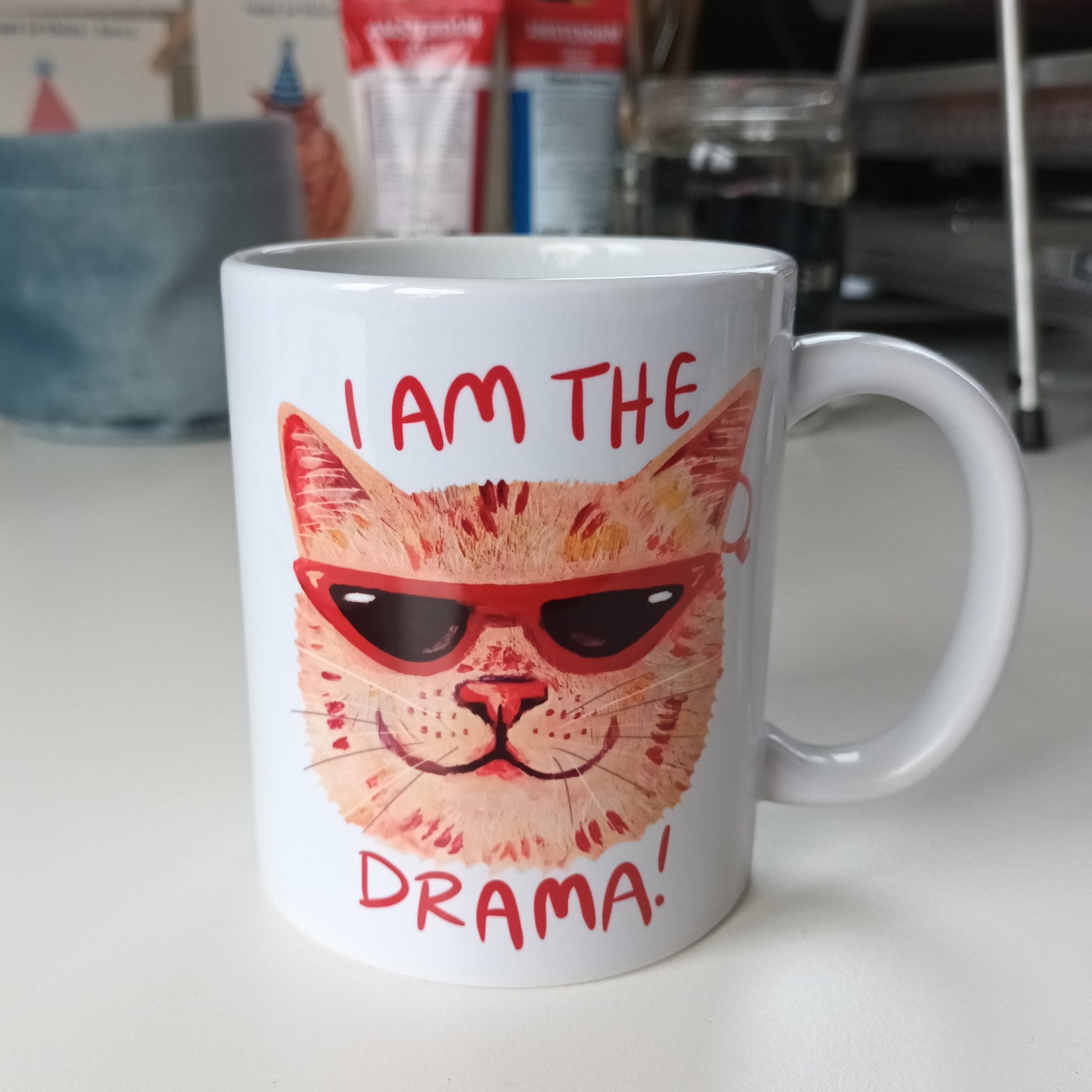 Handmade ceramic mug featuring a dramatic cat design with the text 'I am the Drama Cat', perfect for coffee, tea, or hot chocolate