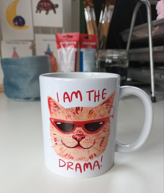 Handmade ceramic mug featuring a dramatic cat design with the text 'I am the Drama Cat', perfect for coffee, tea, or hot chocolate