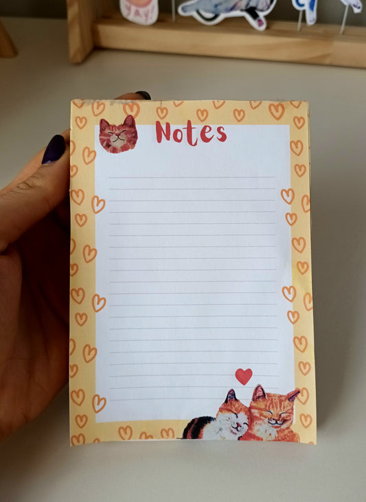 Cute notepad featuring two cats in love, warm yellow-orange colour, available in 30 or 50 pages, printed on eco-friendly paper with a sturdy cardboard back 