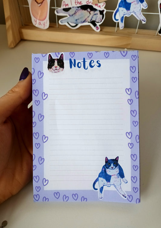 Sassy and cute cat-themed notepad in blue-purple tones, available in 30 or 50 pages, eco-friendly paper with sturdy cardboard backing