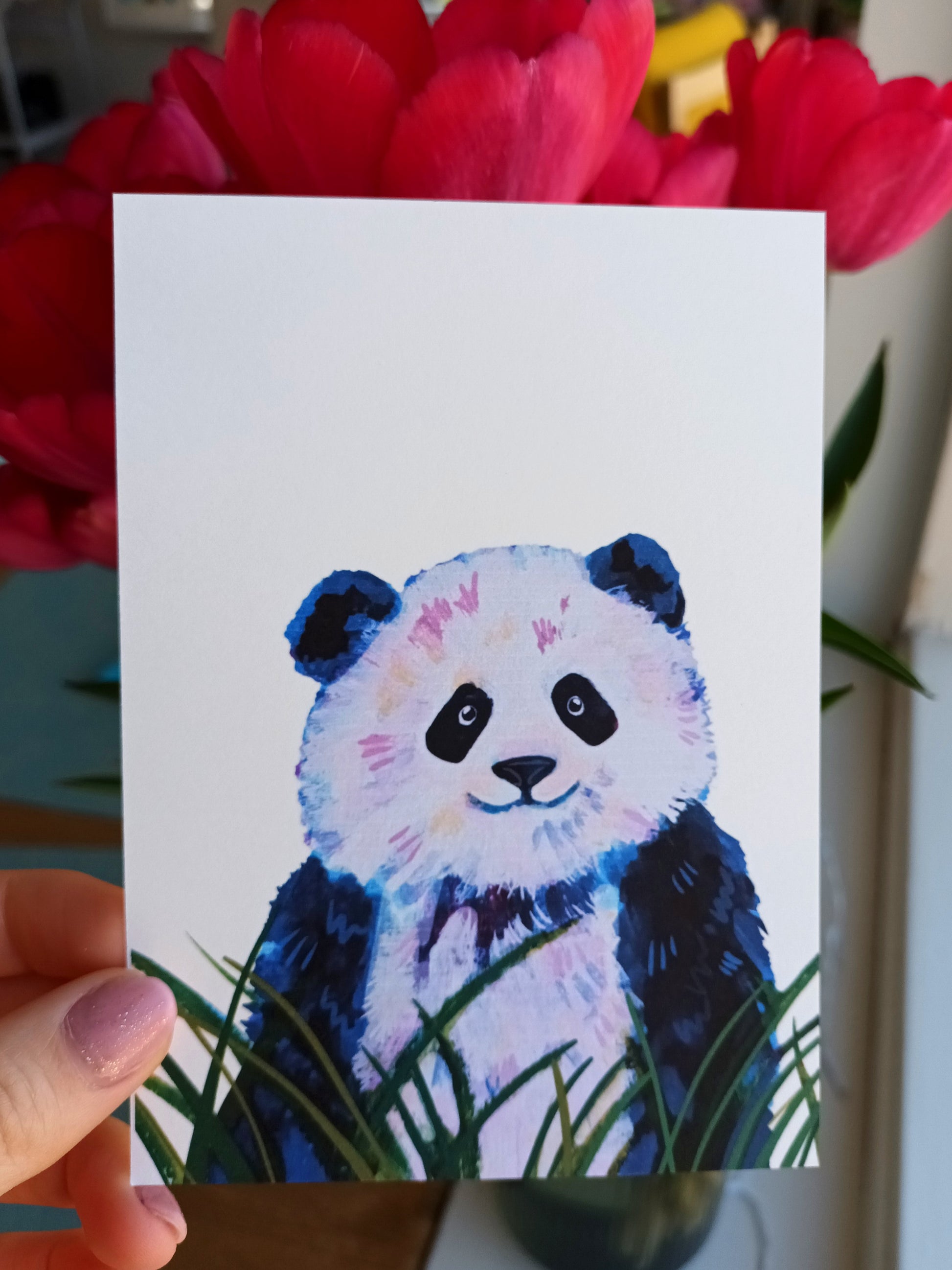 Cute illustrated postcard featuring a panda surrounded by green leaves, printed on eco-friendly matte paper help by hand.