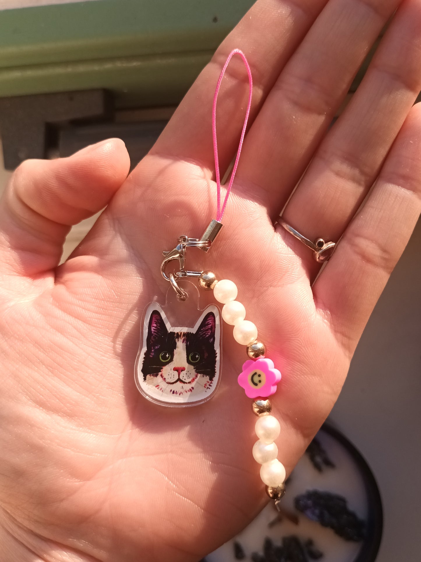 Handmade phone charm with black tuxedo cat acrylic charm, pearls, and colorful beads – a cute accessory for cat lovers