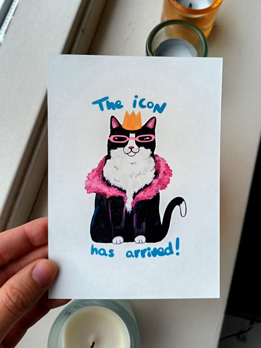 Card with a cat illustration wearing sunglasses and a crown, held by a hand.