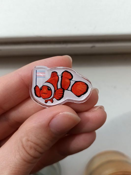Cute clownfish acrylic pin holding transgender flag