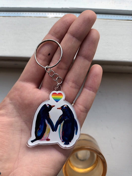 Acrylic keychain with two penguins and a rainbow heart