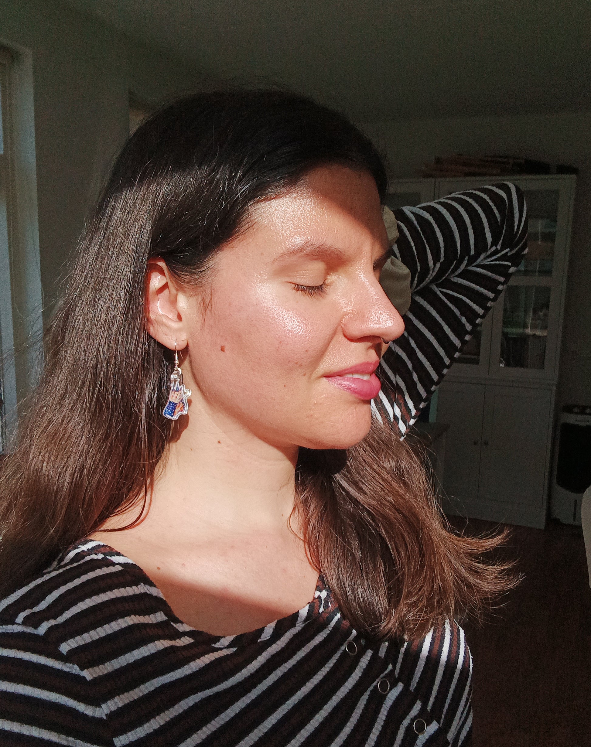 Woman wearing handmade hamster wizard earrings with stainless steel hooks