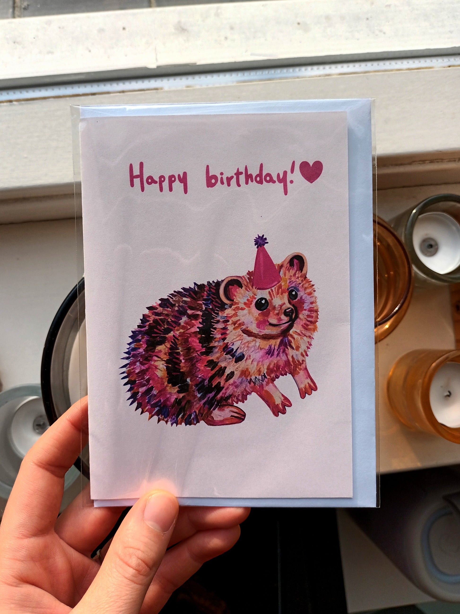 Handmade happy birthday card with cute pink hedgehog illustration, folded greeting card printed on eco-friendly paper.