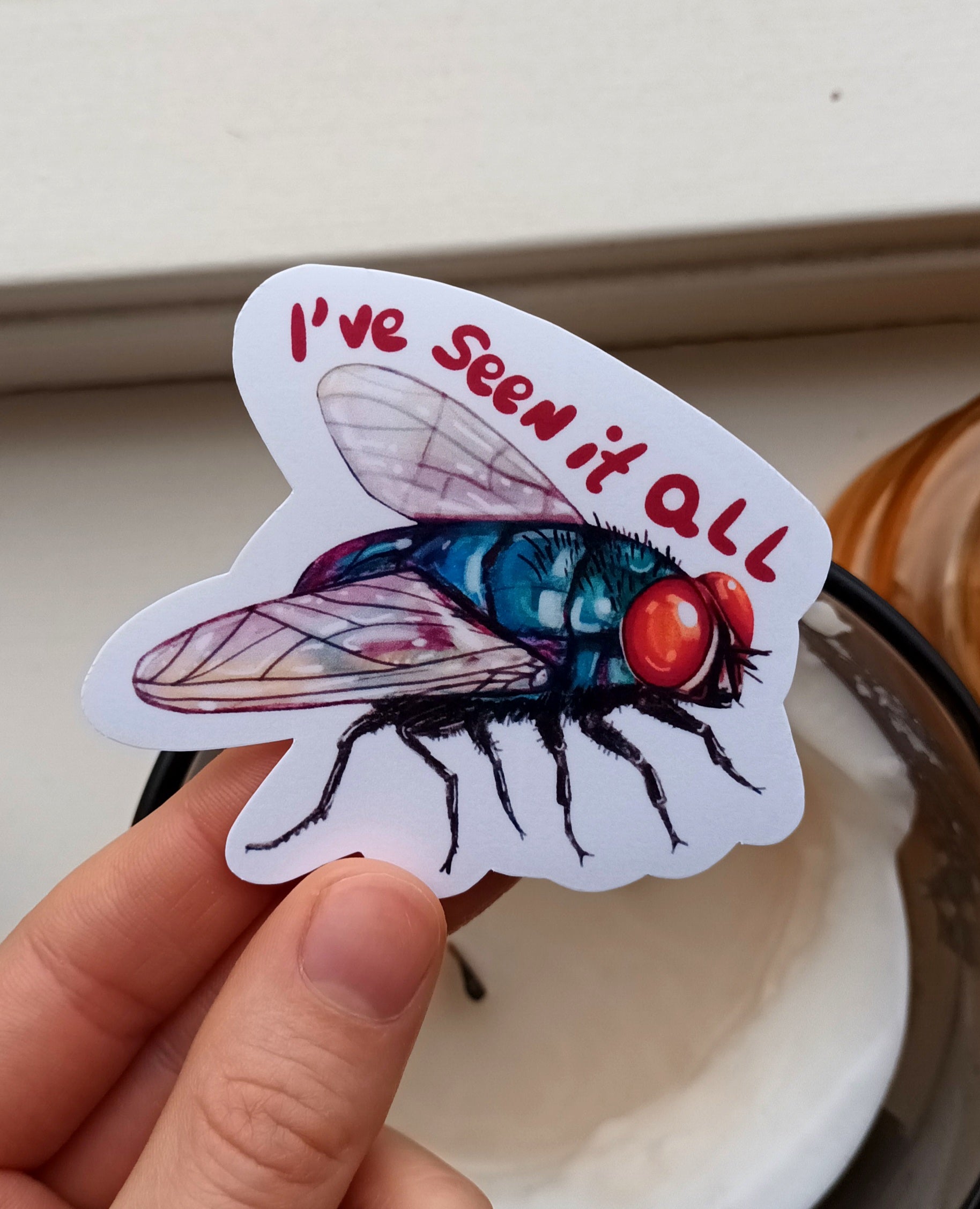 Green bottle fly sticker with “I’ve Seen It All” text, original illustration by the artist, 7.5 x 6.52 cm