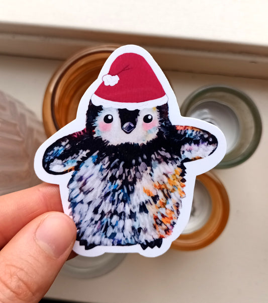 Cute penguin sticker wearing a Santa hat, original Christmas illustration by the artist, 7 x 7.92 cm