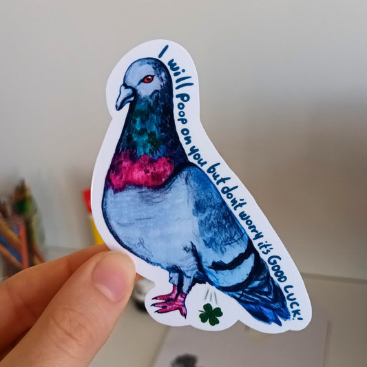 Hand holding a sticker of a pigeon with text.