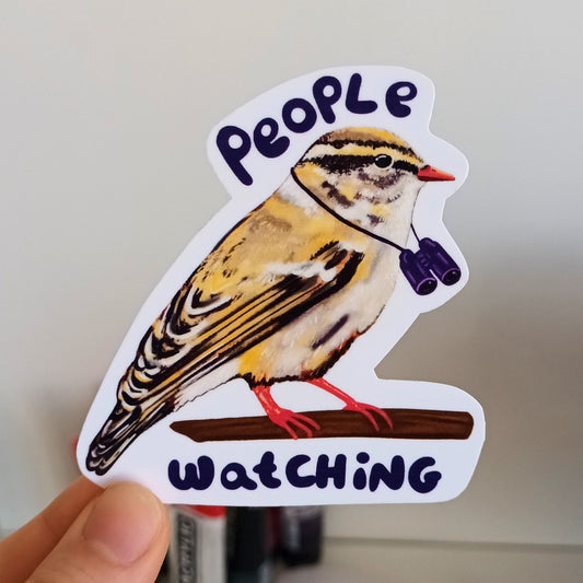 Sticker of a bird with 'People Watching' text held by a hand.