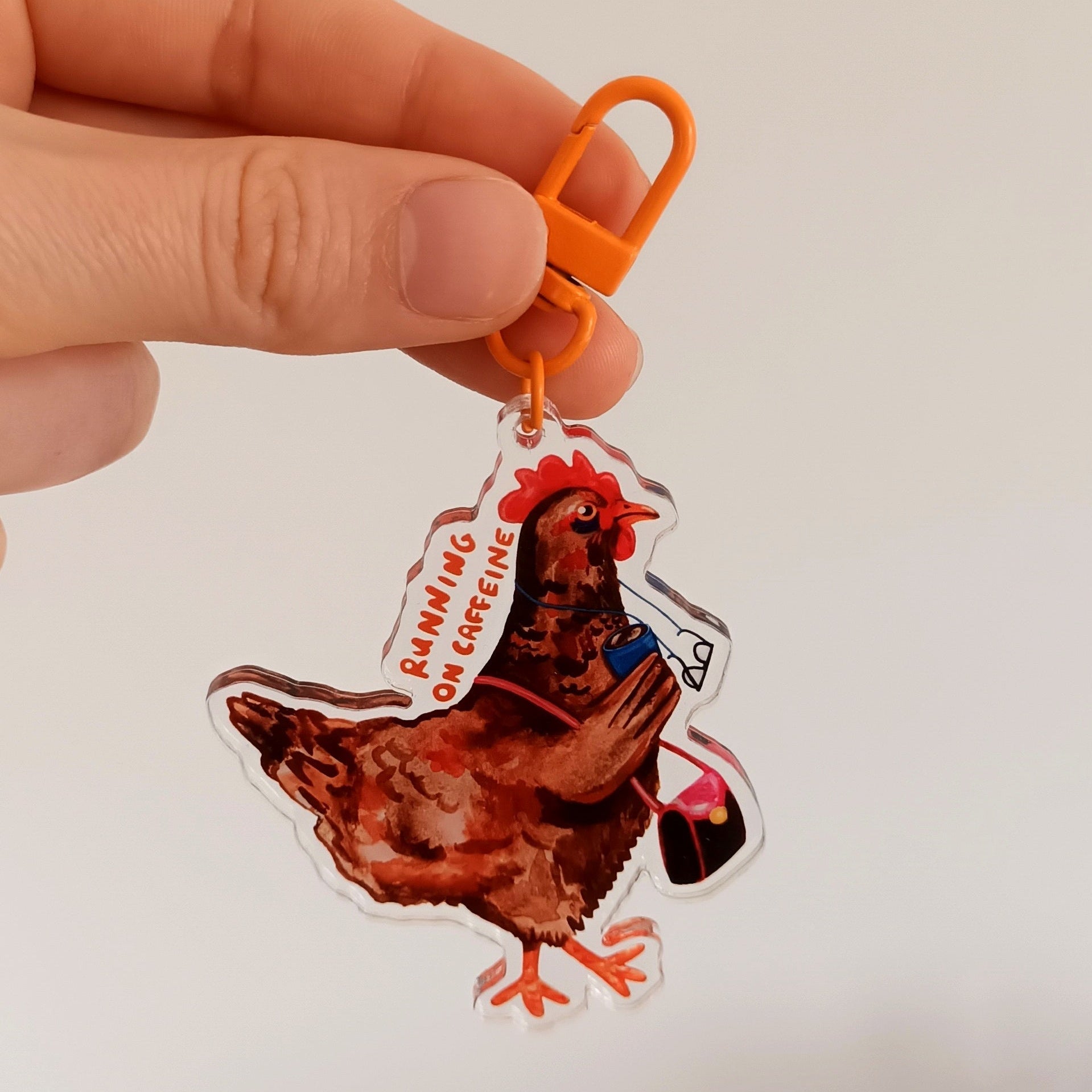 Keychain with chicken saying "Running on caffeine"