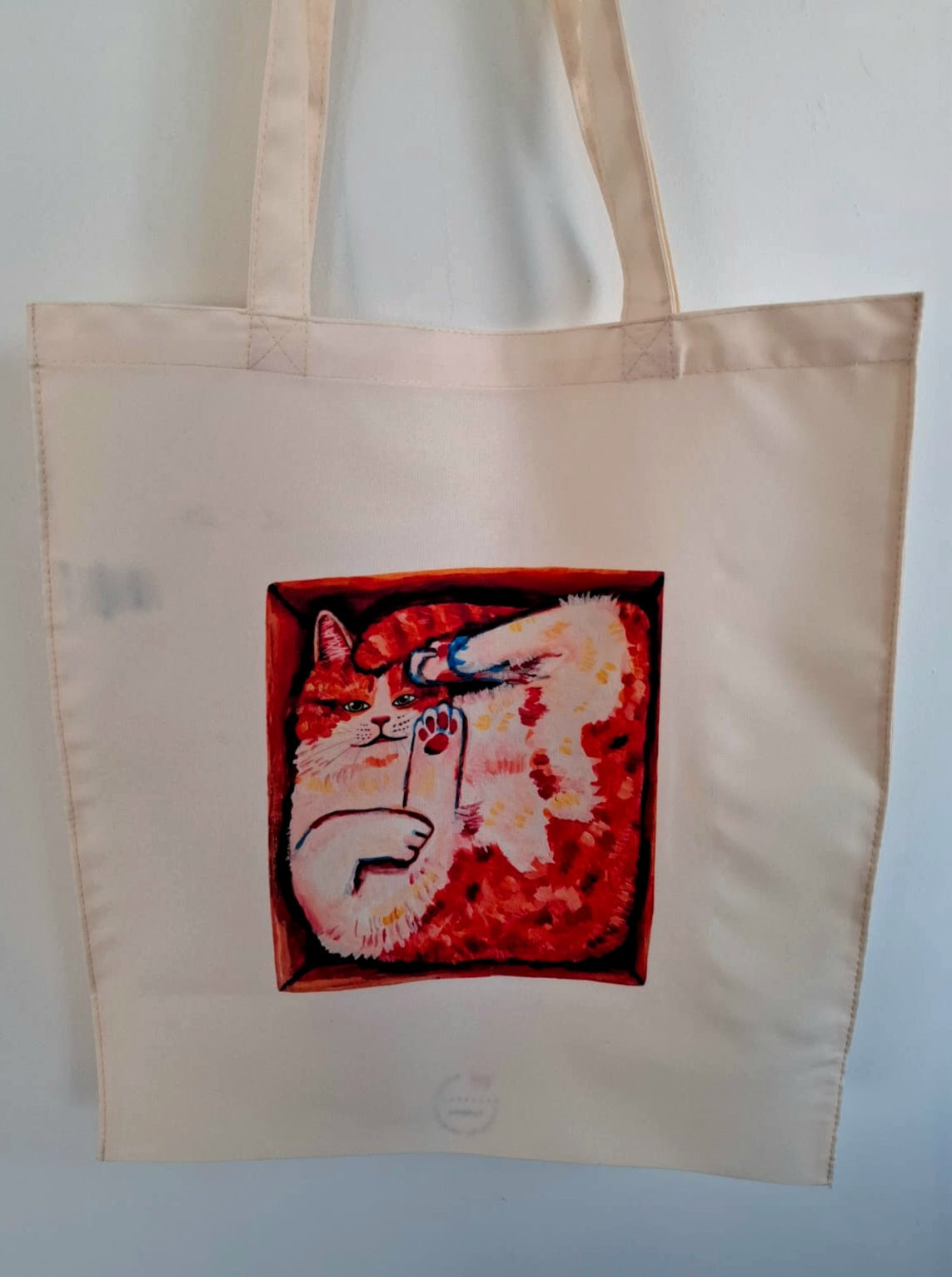 Tote bag featuring a cute orange cat in a box, hand-painted and printed by the artist, made of waterproof 100% polyester, closeup