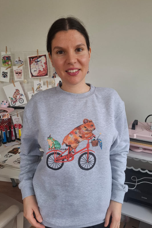 Light grey eco-friendly sweater with cute hamster cycling and frog familiar design, made from organic cotton and recycled polyester.