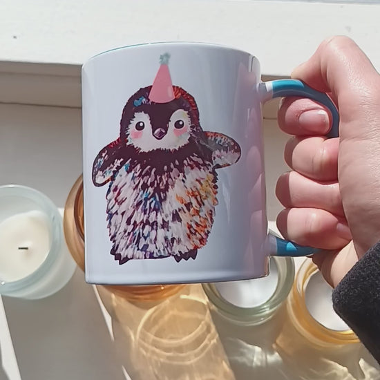 Cute penguin mug with pink party hat and blue handle