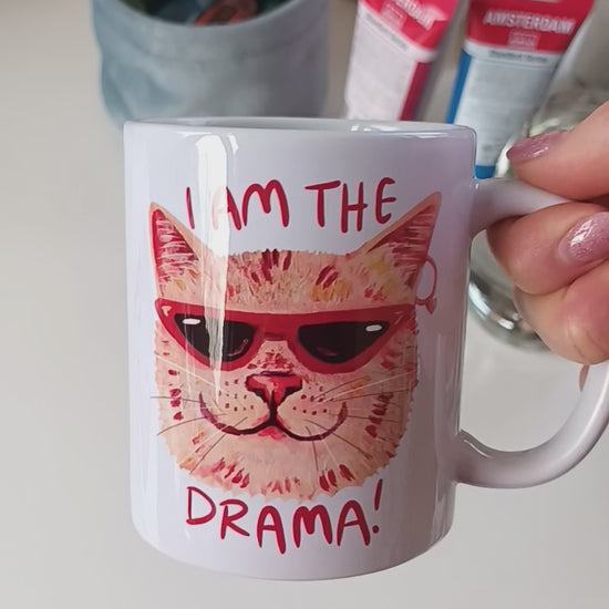 Handmade ceramic mug featuring a dramatic cat design with the text 'I am the Drama Cat', perfect for coffee, tea, or hot chocolate video